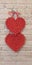 Red hearts hang on brick wall. Textured symbol of love. Lovers symbol