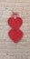 Red hearts hang on brick wall. Textured symbol of love. Lovers symbol