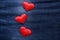 Red hearts on jeans background