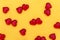 Red hearts lie on a yellow background. Concept for valentine`s day.