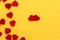 Red hearts lie on a yellow background. Concept for valentine`s day.