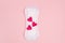 Red hearts and daily, menstrual woman pad for hygiene or blood period on pink background