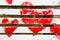 Red hearts painted on a white wooden bench