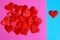 Red hearts on a pink and blue surface. Love and gender differences