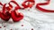 Red hearts with red satin ribbon on marbled background. Minimalistic St Valentine\\\'s day concept. Satin ribbons