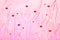 Red hearts on sparkling textured pink background