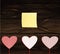 Red hearts on a stick with the image. Yellow sheet of paper for