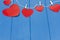 Red hearts on a string on a blue background