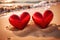 Red hearts together on the beach, showing holiday summer romance