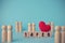 Red hearts on wood blocks with text blocks written on 14 February and many couples doll wood on blue background with a copy space