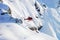 Red helicopter flying near Swiss Alpine mountain Mannlichen in w