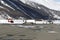 A red helicopter, a fuel truck and a private jet in the airport of St Moritz in the snowy alps switzerland in winter