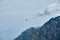 Red helicopter in the sky over the Caucasus Mountains, a beautiful mountain landscape