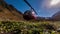 Red helicopter stands parked in the mountains on the meadow