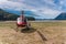 Red helicopter together with bicycle are on the beach in Alaska.