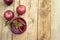 Red herbal and fruit tea in glass cup and tea with plums. Rustic textured wooden table. Copy space.