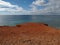 Red high cliffs at Praia da Falesia, a paradise beach in Albufeira in Portugal