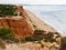 Red high cliffs at Praia da Falesia, a paradise beach in Albufeira in Portugal