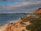 Red high cliffs at Praia da Falesia, a paradise beach in Albufeira in Portugal