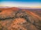 Red hills and rugged peak at sunset.