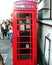 A red historic phone box in London.