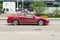 Red Honda Accord Eighth generation car driving fast on the open road