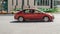 Red Honda Civic eighth generation car moving on the street in motion