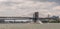 Red Hook barge passes under Brooklyn Bridge, East River, New York