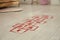 Red hopscotch floor sticker in room, closeup