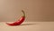 Red hot chili pepper on brown background. Minimal food concept.