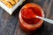 Red Hot Chili Pepper Sauce for Artisan Cheese made with Vinegar and Sugar in Glass Bowl with Spoon