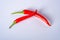 Red hot chilli pepper on a white background. Chilli pepper ready to cook. Peppers lie on acrylic