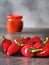 Red hot chilli peppers and ajvar on dark table