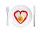 Red hot chilly peppers and fried egg on white plate isolated