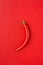 Red Hot Spicy Chili Pepper on Crimson Monochrome Background. Food Poster. Conceptual minimalist flat lay, Mexican Italian Cuisine