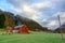 The red house on the green fields and the sky is beautiful clouds at Voss waterfall in Vossevangen