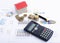 Red house with money coins and calculator and fountain pen on document report for business finance concept