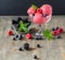 Red ice cream with berries, sorbet on wooden dark background