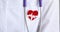 Red icon in form of heart electrocardiogram hanging on doctor chest closeup 4k movie