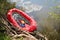 Red inflatable boat with oars raft for rafting along a  river