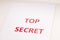 Red inscription TOP SECRET on a white sheet. Secrets and conspiracies. Archives of documents. Financial statements.