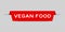 Red inserted label with word vegan food on gray background