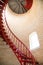 Red iron spiral staircase inside a lighthouse