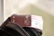 Red Islamic Republic of Iran passport with airline tickets on touristic backpack