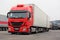 Red Iveco and other Cargo Trucks on Warehouse Yard