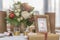 Red and ivory floral arrangement prepared for reception, wedding table with candle and setting, winter concept