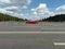 Red Jaguar E-Type car on street during retro-cruise