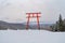 Red Japanese Torii pole, Fuji mountain and snow in Kawaguchiko, Japan. Forest trees nature landscape background in winter season