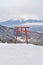 Red Japanese Torii pole, Fuji mountain and snow in Kawaguchiko, Japan. Forest trees nature landscape background in winter season