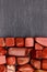 Red jasper heap stones texture on half black stone background. Place for text